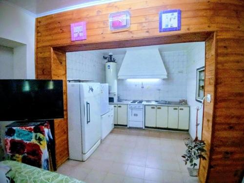 a kitchen with a white refrigerator and white appliances at La Casona Hostel in Bermejo