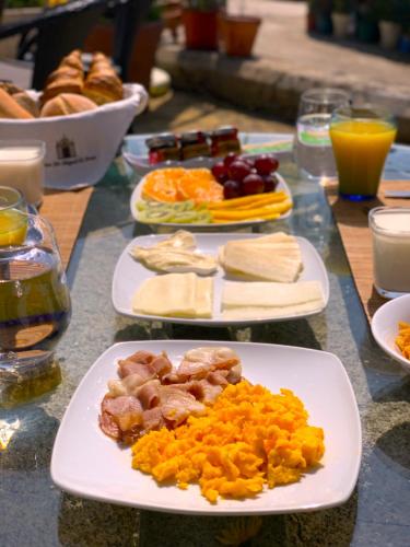 a table with plates of food on a table at Quinta Sao Miguel de Arcos in Vila do Conde