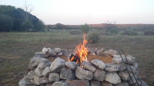 a fire pit filled with rocks in a field at Kleinfontein in Clanwilliam