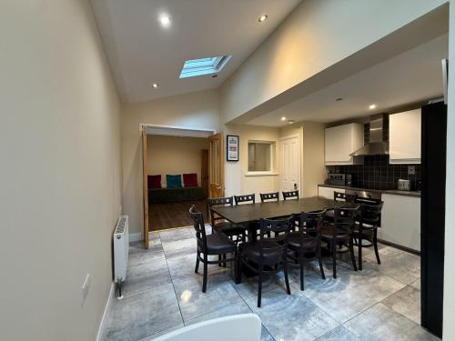 a kitchen and dining room with a table and chairs at The Townlets Townhouse - 5BR - sleeps 13 in Belfast
