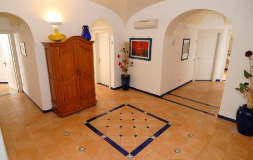 a room with a wooden door and a tile floor at Hotel Bellevue Suite in Amalfi
