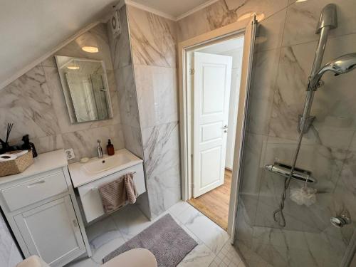 un baño con ducha y lavabo en Family & Worker Accommodations in Uddevalla, en Uddevalla