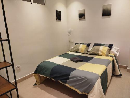 a bedroom with a bed with a striped blanket at Nunes Luxury in Ronda