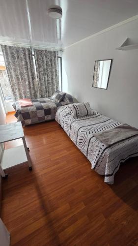 Ένα ή περισσότερα κρεβάτια σε δωμάτιο στο Casa Central A pasos Del Mall y cercanos a playas