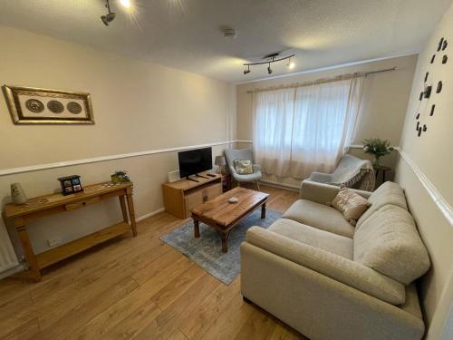 a living room with a couch and a table at Cosy Family Home in Lovely Stony Stratford in Stony Stratford