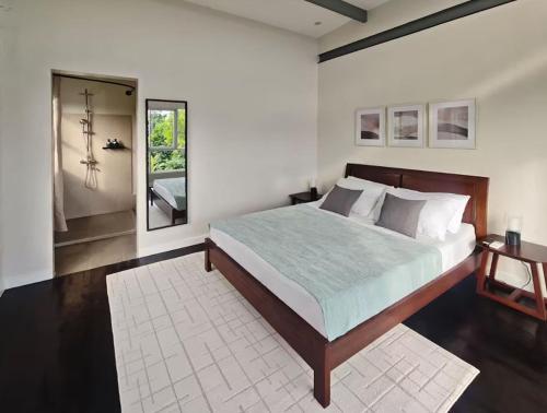 a bedroom with a large bed and a mirror at Kalma - 2 Bedroom Villa with Private Pool in Santander