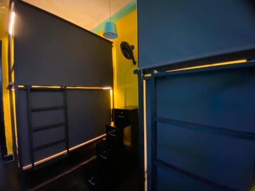 a large blue door in a room with a light at Casona Don Juan Hostel in San Gil