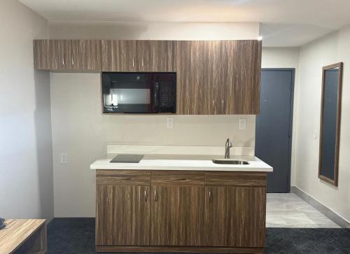 a kitchen with a sink and a microwave at Quality Inn Ponca City in Ponca City