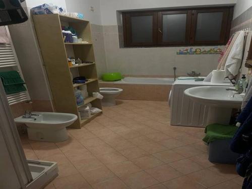 a bathroom with two sinks and a tub and a toilet at SnowPeak Residence in Dresano