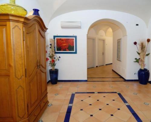a room with a hallway with a painting on the wall at Hotel Bellevue Suite in Amalfi