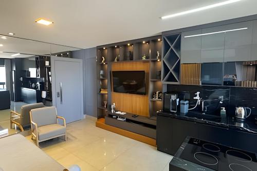 Zimmer mit einer Küche mit Herd und einem TV in der Unterkunft High Luxury Geta on the 18th Floor Vertigo Studios in Campo Grande