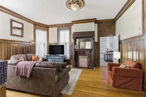 a living room with a couch and a tv at Historic Midtown Apartment in Memphis