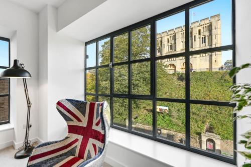 a chair in a room with a window at Castle View by Ginger & Gold Luxury Norwich Apt in Norwich