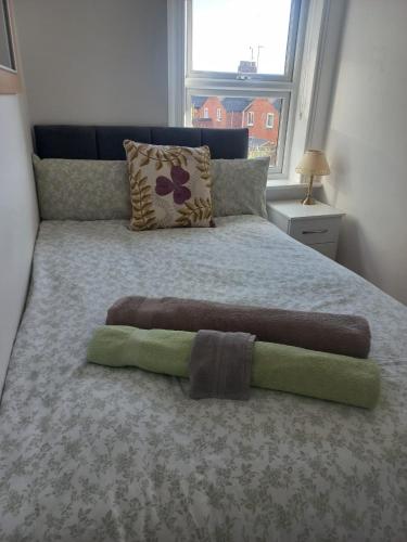 a bed in a bedroom with a large bed with a window at CosyHomeStay Evesham in Evesham