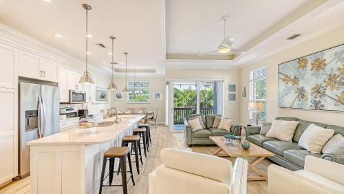 a kitchen and living room with a couch and a table at Casa Junonia - 1032L in Siesta Key