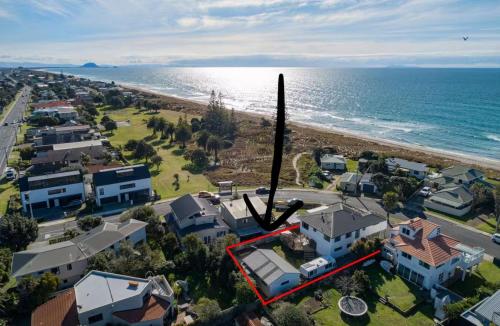 an aerial view of a house next to the ocean at The Sugar shack in Tauranga
