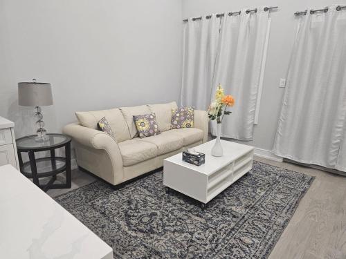 a living room with a couch and a vase of flowers at Brand new custom 4BR house in Oshawa
