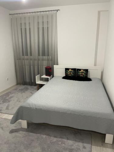 a bedroom with a large bed in a room at Flat in Fushë Kosova in Kosovo Polje