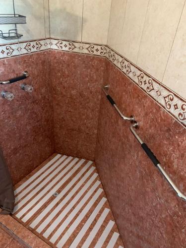 a shower with a bench in the middle of a room at Apartamento la 20 in Tijuana