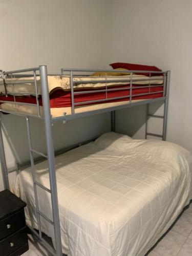 two bunk beds in a room with a bed at Apartamento la 20 in Tijuana