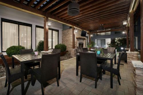 a patio with tables and chairs and a fireplace at Courtyard by Marriott Dallas DFW Airport North/Irving in Irving