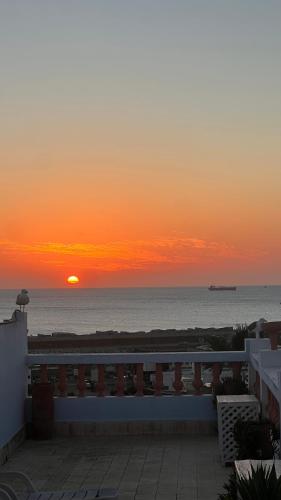 a sunset over the ocean with the sun in the distance at Ryad du Pêcheur Safi in Safi
