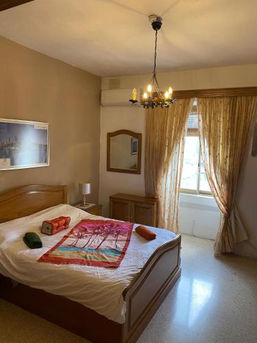 a bedroom with a bed and a window at Birgu SeaView Apartment in Birgu