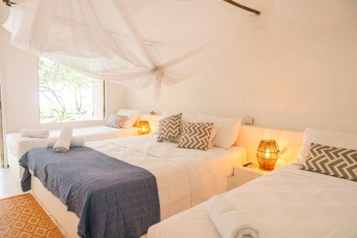 Giường trong phòng chung tại Casa Rosario