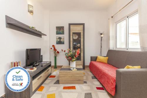 a living room with a couch and a tv at B81 - Casa do Outeiro Westcoast Home in Vila do Bispo