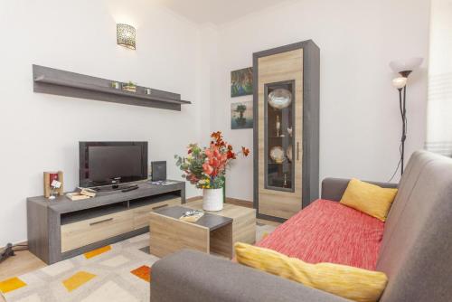 a living room with a couch and a tv at B81 - Casa do Outeiro Westcoast Home in Vila do Bispo
