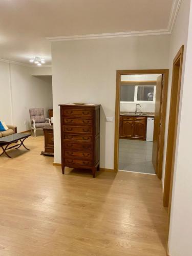 a living room with a dresser and a kitchen at Casa do Mosteiro in Cabeceiras de Basto