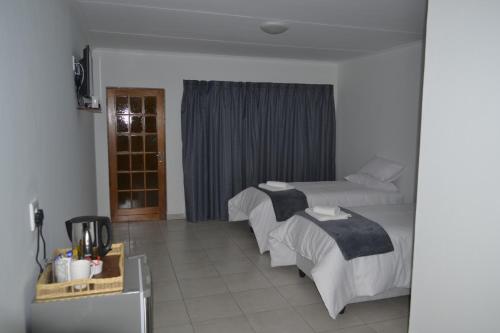 Ένα ή περισσότερα κρεβάτια σε δωμάτιο στο La Palma Lodge