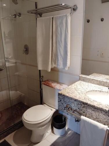 a bathroom with a toilet and a sink at Apart hotel Barra First in Rio de Janeiro