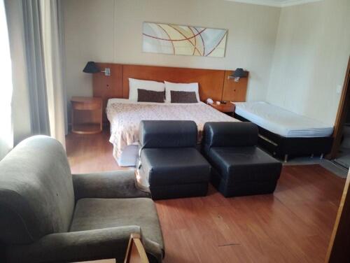 a living room with a bed and a couch at Apart hotel Barra First in Rio de Janeiro
