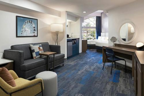 a hotel room with a couch and a desk at City Express by Marriott Santa Ana/Orange County Airport in Santa Ana
