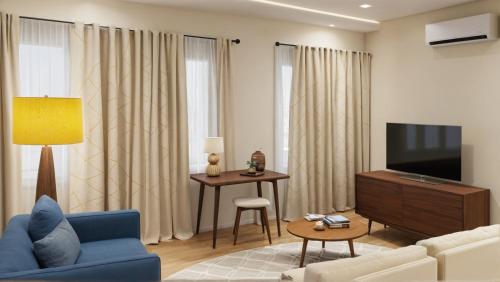a living room with a blue couch and a tv at Modern 4 & 5 BR Townhomes Minutes from Downtown LA in Los Angeles