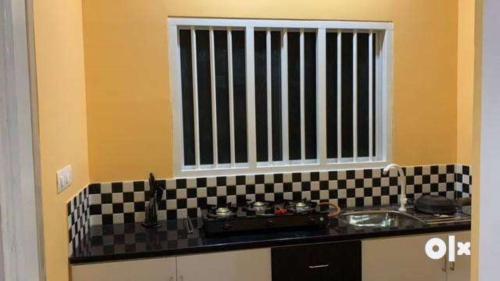 a kitchen with a sink and a window at Charis Villa and Guest house 5bed 4bath in kunnamkulam in Kunnamkulam