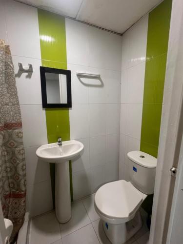a small bathroom with a toilet and a sink at Aparta estudio Santa Marta in Santa Marta