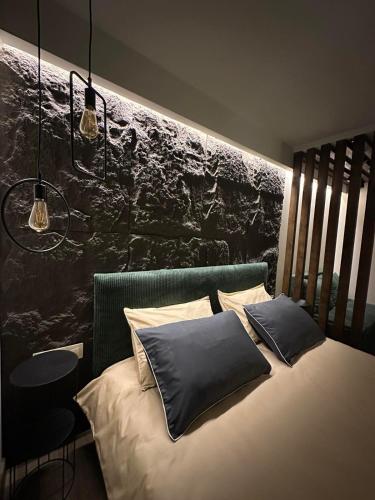a bed with two pillows on it in a room at Къща за гости Рилски чардак in Sapareva Banya