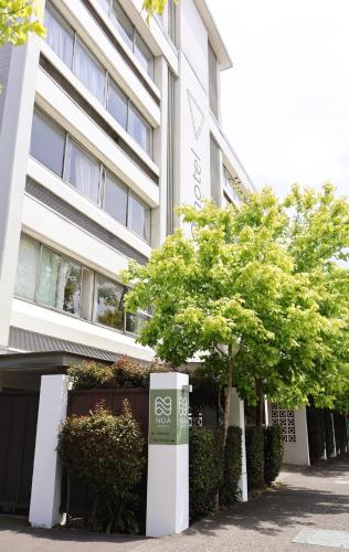 a building with trees in front of it at Noa Hotel in Auckland