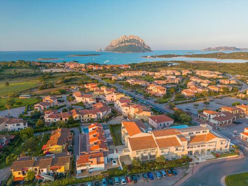 an aerial view of a town next to the ocean at ISA - Residence with panoramic swimming pool in Porto San Paolo just 850 mt from the sea in Porto San Paolo