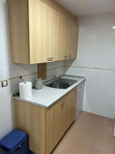 a small kitchen with a sink and a blue stool at Apartamento Playa en Manilva in San Luis de Sabinillas