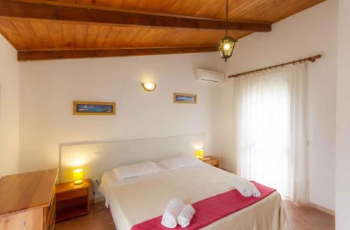 Ένα ή περισσότερα κρεβάτια σε δωμάτιο στο House and Apts in Alghero 27113