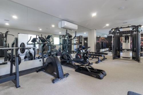 a gym with several treadmills and cardio machines at Apt beira-mar no Eco Resort Praia dos Carneiros in Praia dos Carneiros