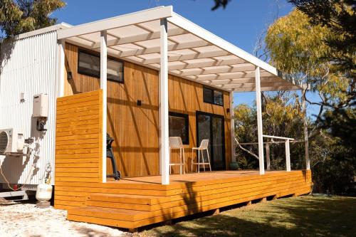 a wooden house with a pergola on top of it at Whittle Home - NEW TINY HOME in Robe