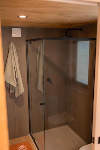 a shower with a glass door in a bathroom at Whittle Home - NEW TINY HOME in Robe