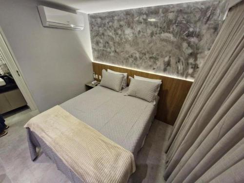 Giường trong phòng chung tại Melhores Flats - Excelente, pertinho do mar