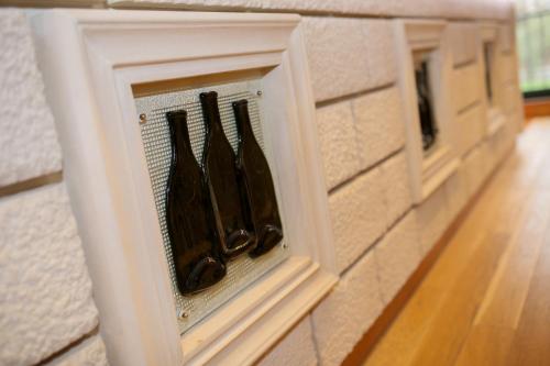 a row of wine bottles in a wine rack on a wall at Villa Salvia in Mostar