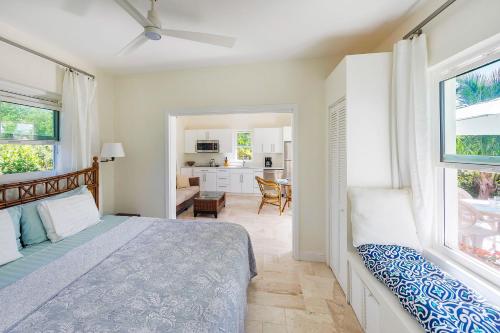 a bedroom with a bed and a living room at Chuchubi Cottage in Long Bay Hills