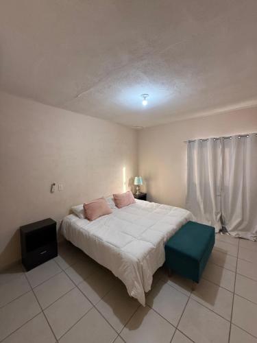 a bedroom with a large bed and a television at Departamento Privado en Los Cabos in San José del Cabo